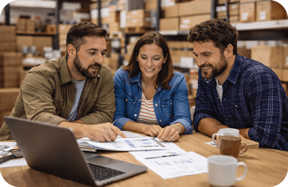 Oneir team collaborating around documents and laptop
